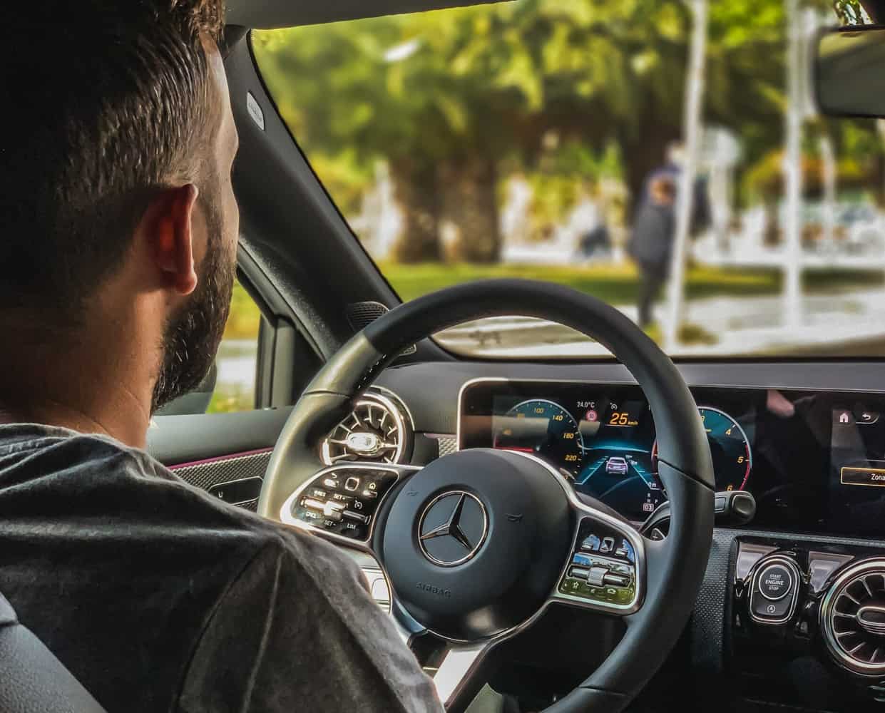 Young man driving an SUV.
