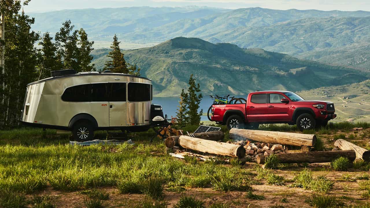 Truck pulling a small camper