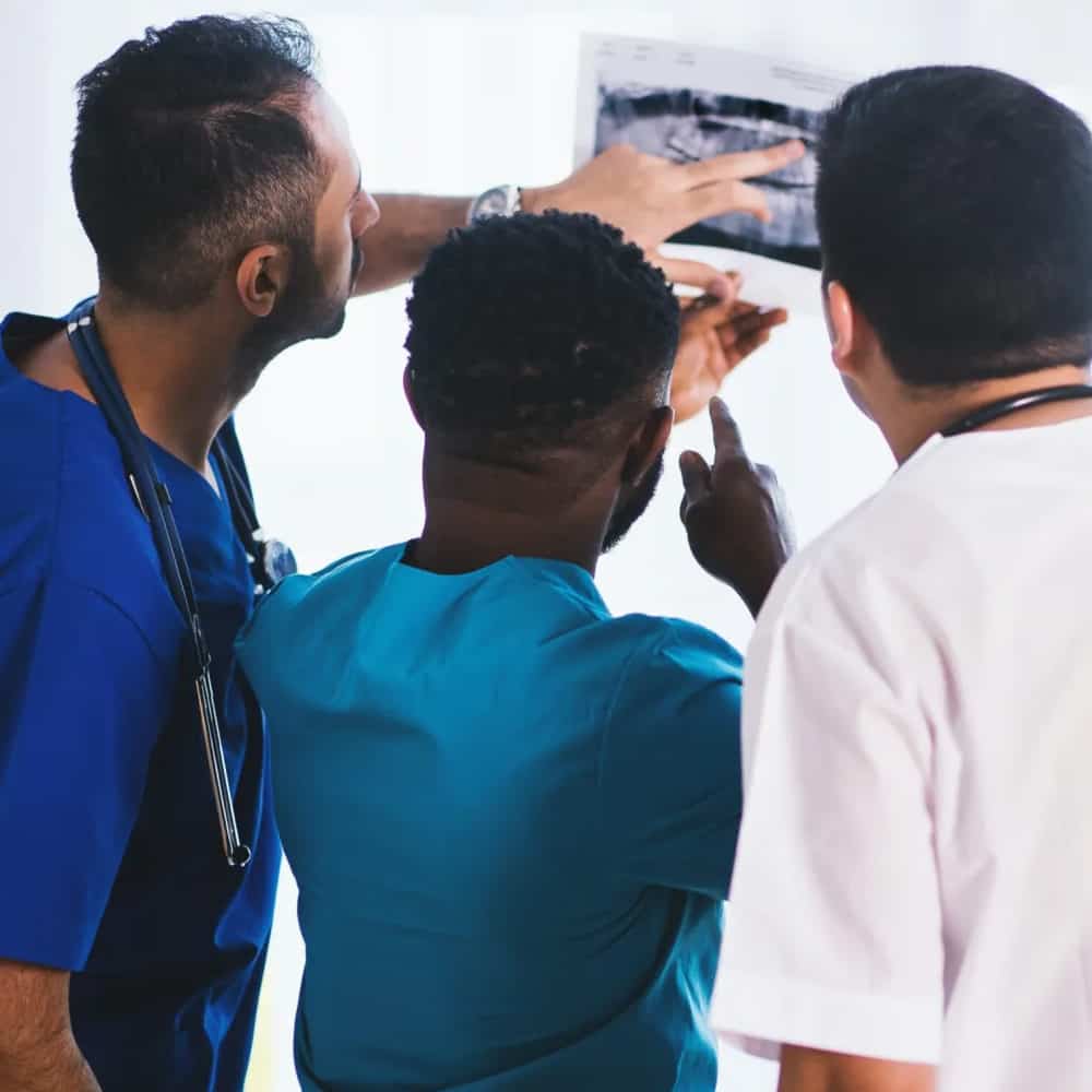 Group of doctors looking at a scan 1979