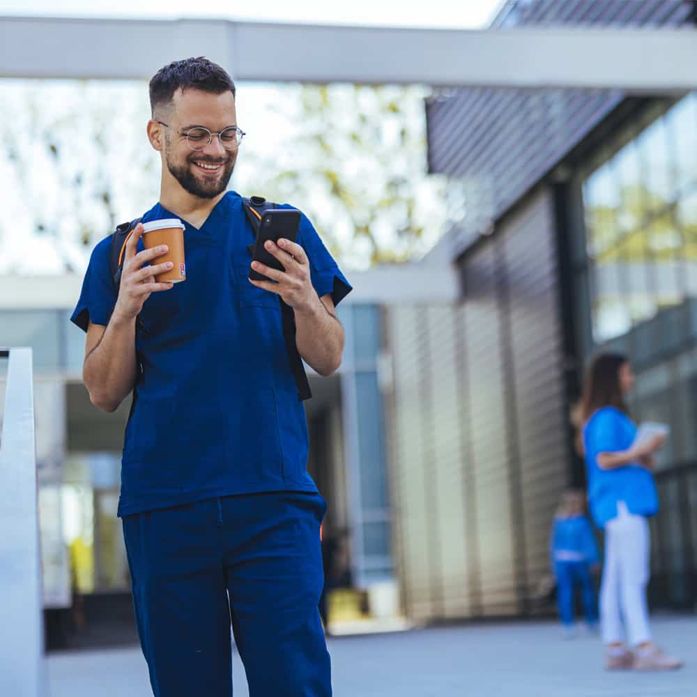 Young male nurse on his cell phone.