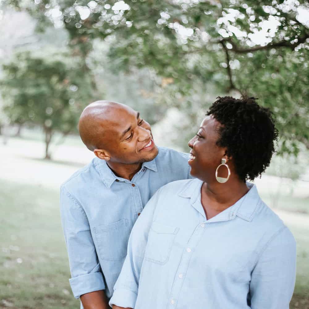 African American couple hugging.