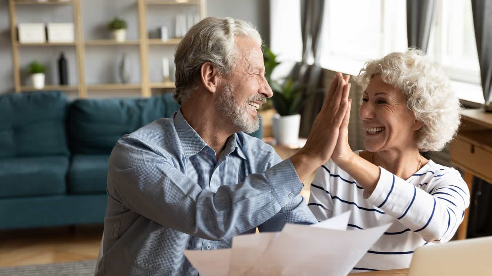 People sitting in from of Airstream camper.