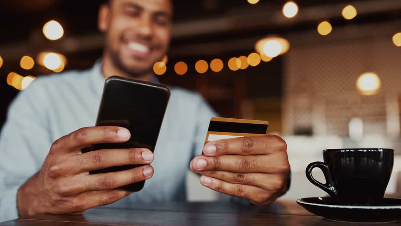 A guy using his card to login to make a payment.