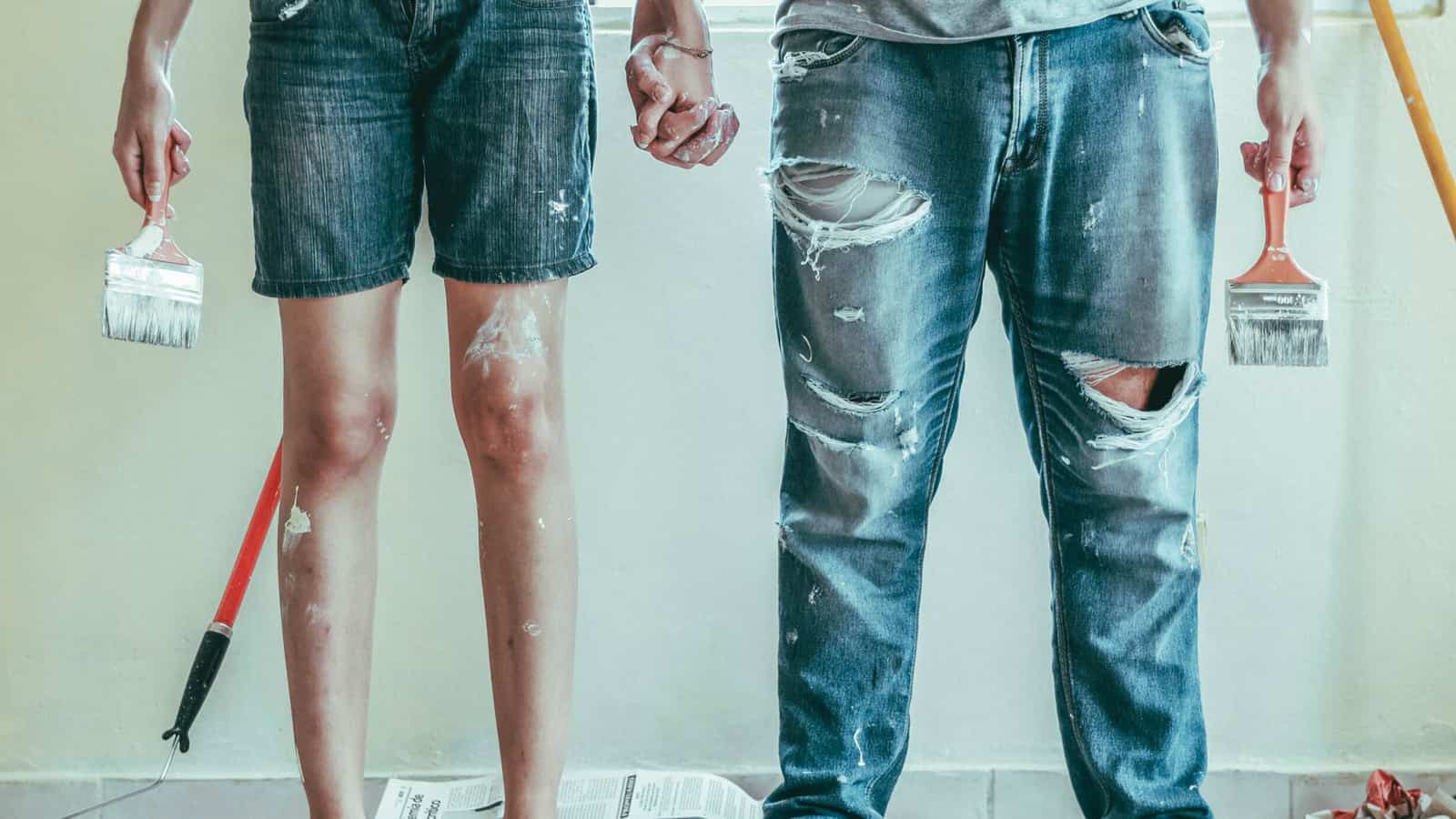 Couple standing in front of new home.