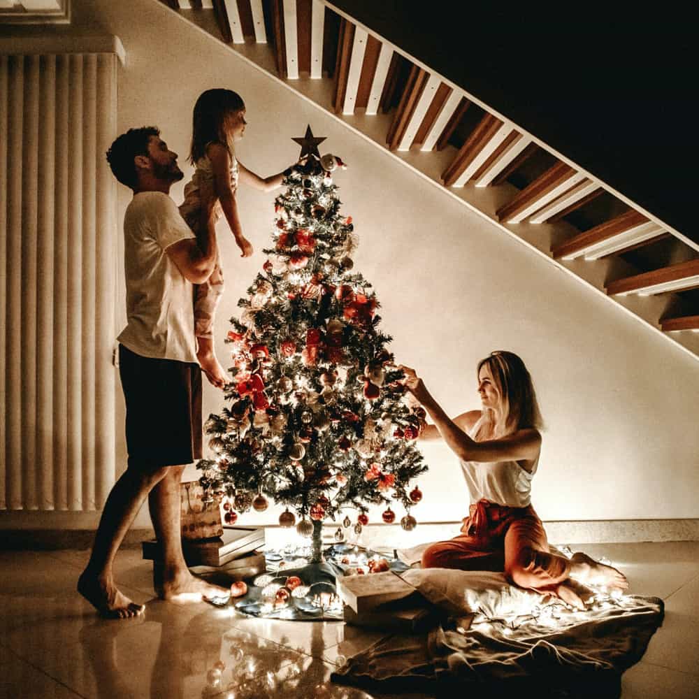 Family gathering around a Christmas tree.