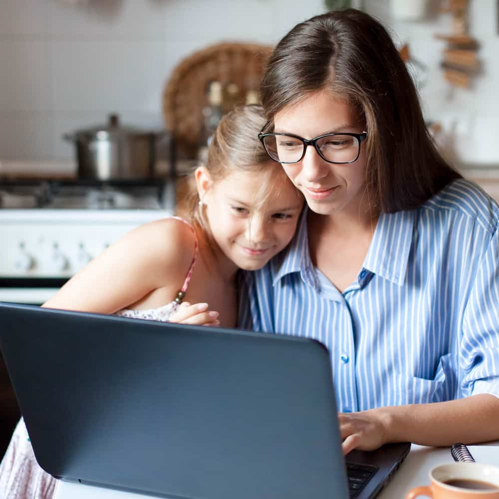 Woman and young daughter on laptop