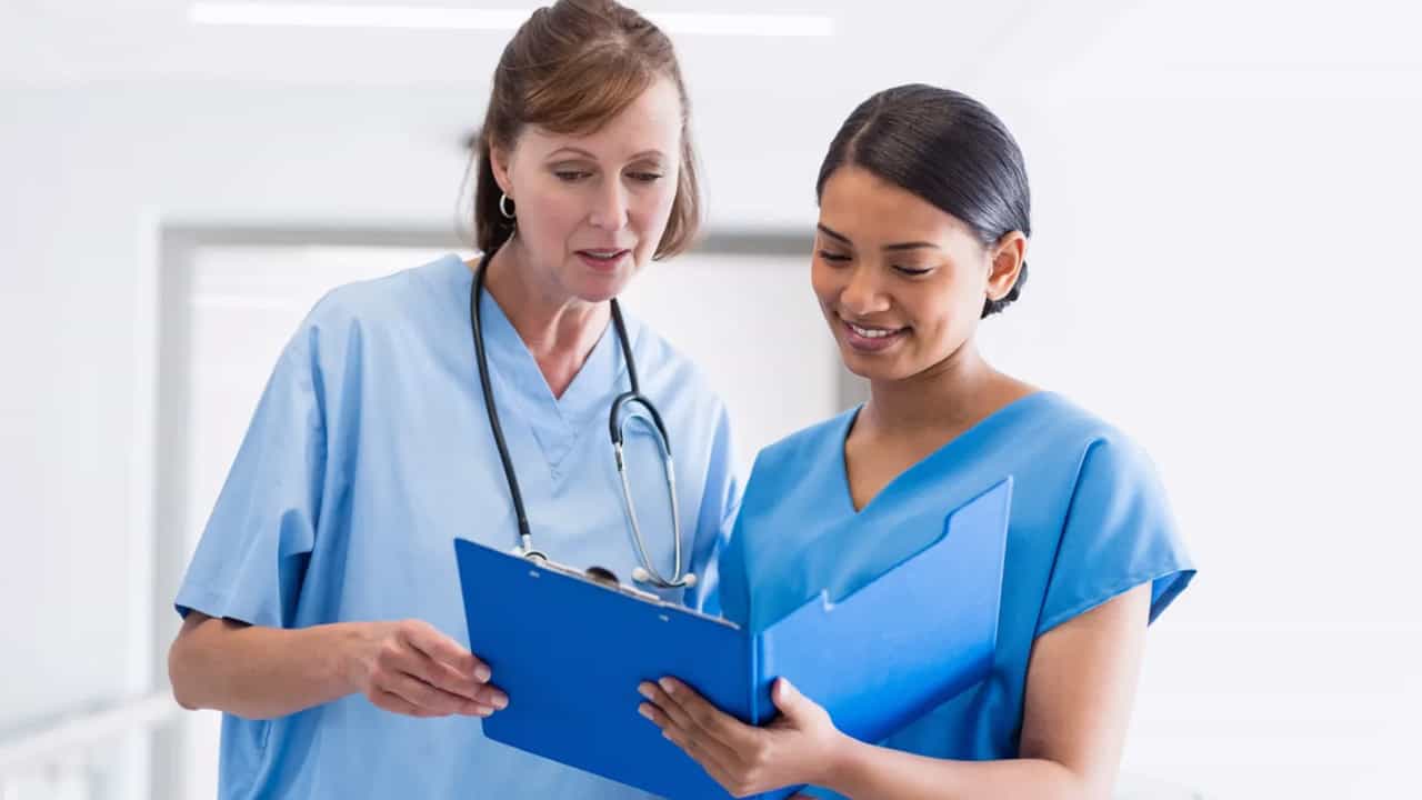 Two nurses talking.